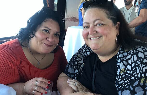 Two Chronus colleagues smile together at a team event