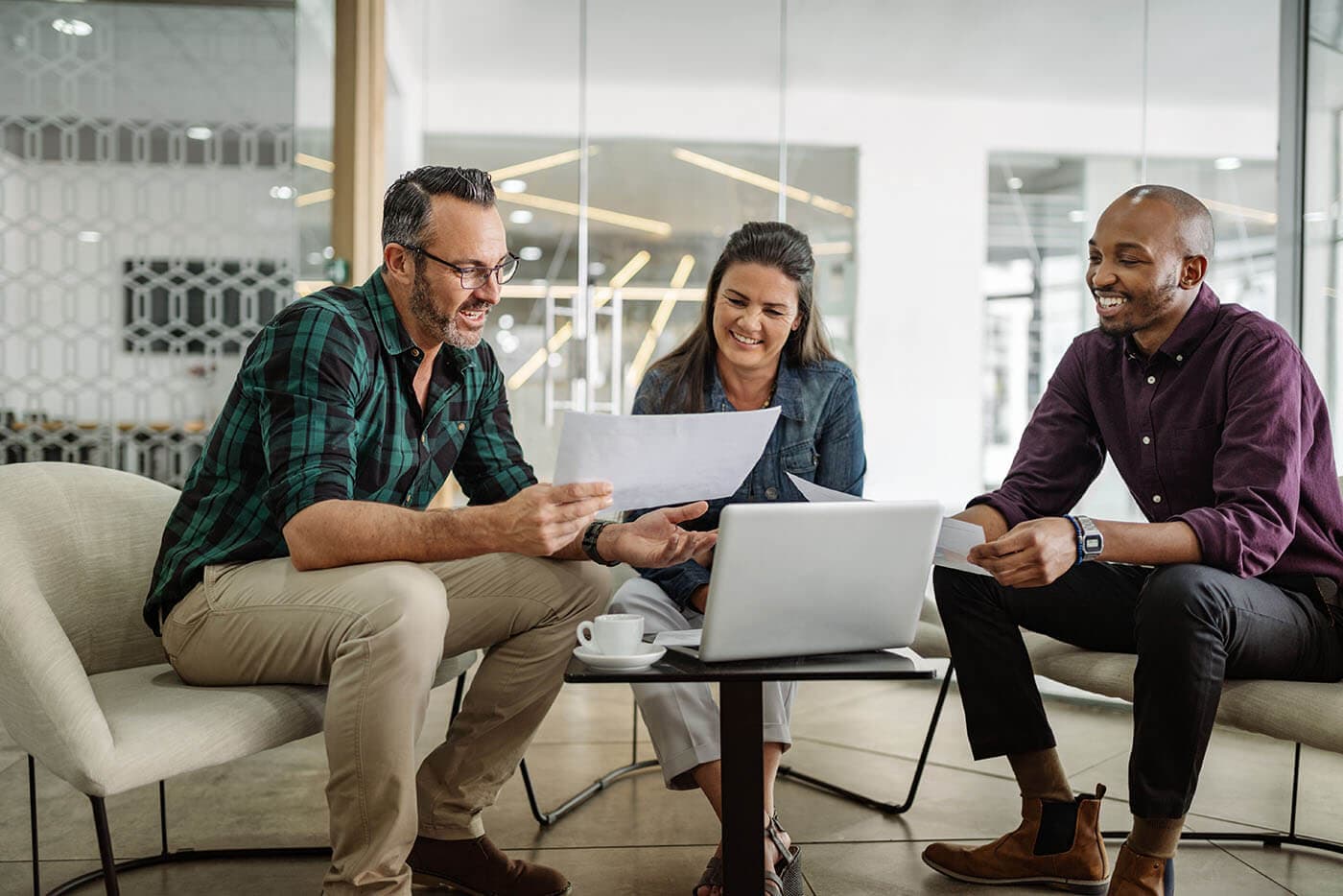 male employee at ERG meeting sitting next to female colleague smiling