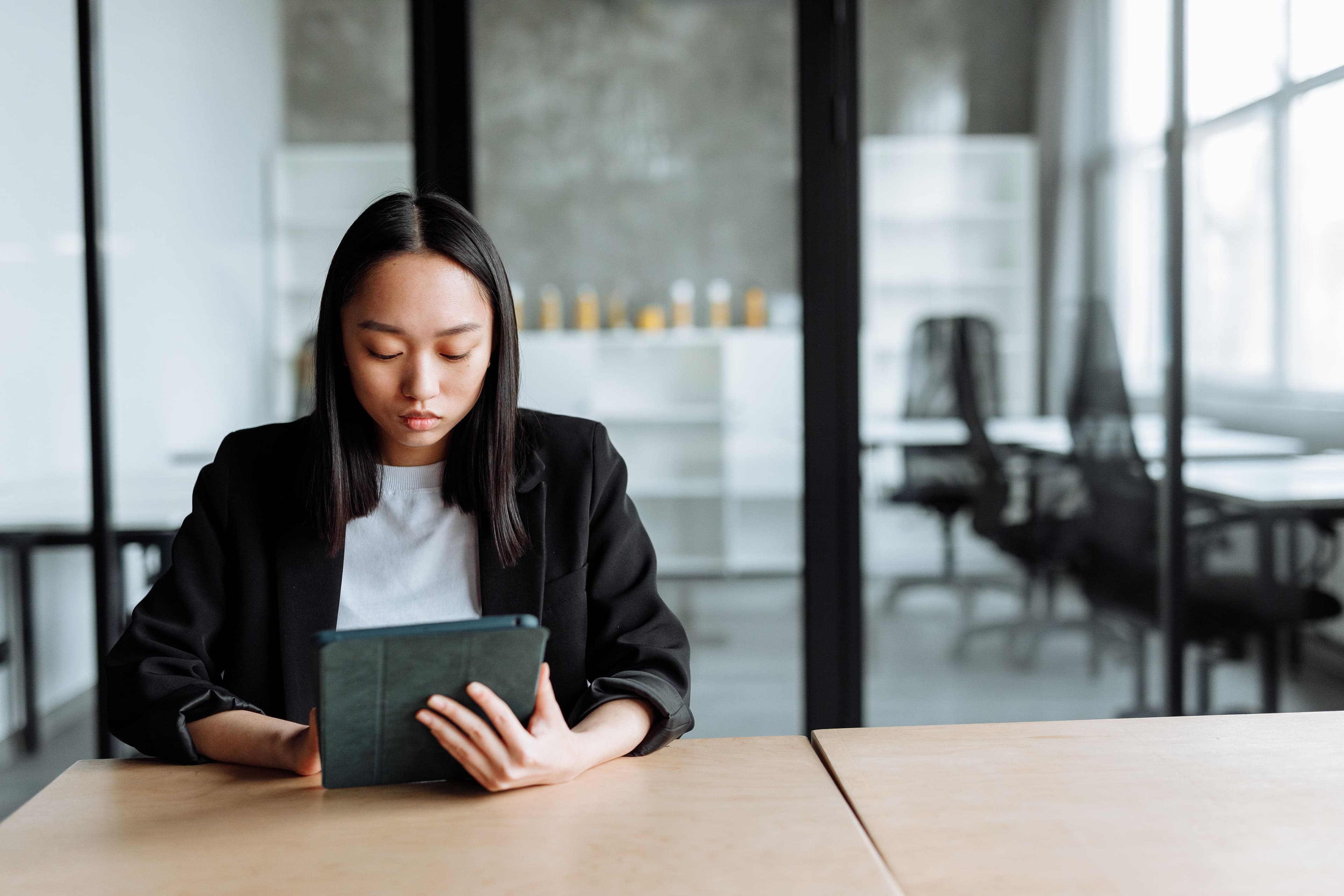 woman on her tablet looking for employee wellbeing reosurces