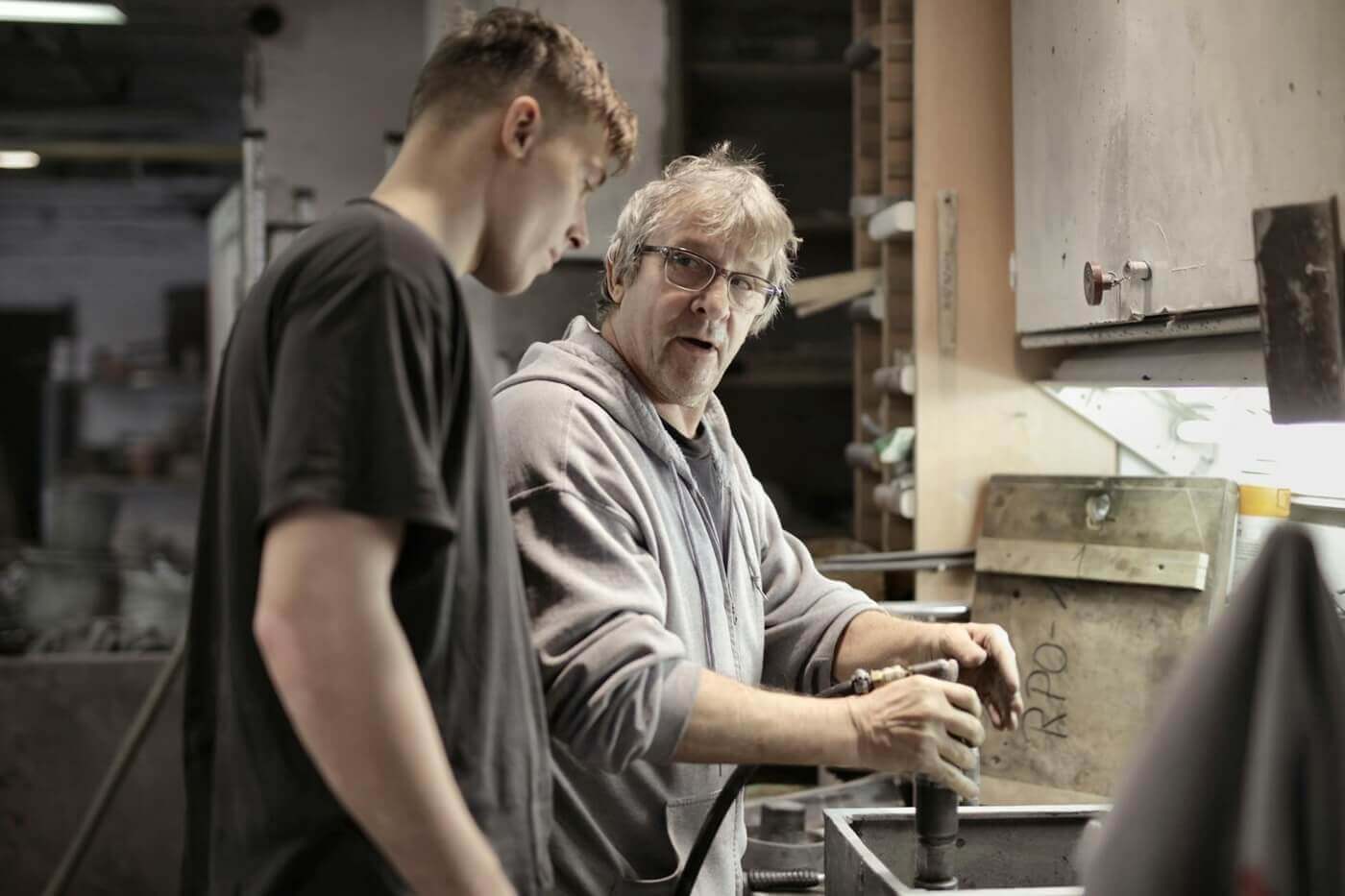A mentee learns from a mentor in a workshop